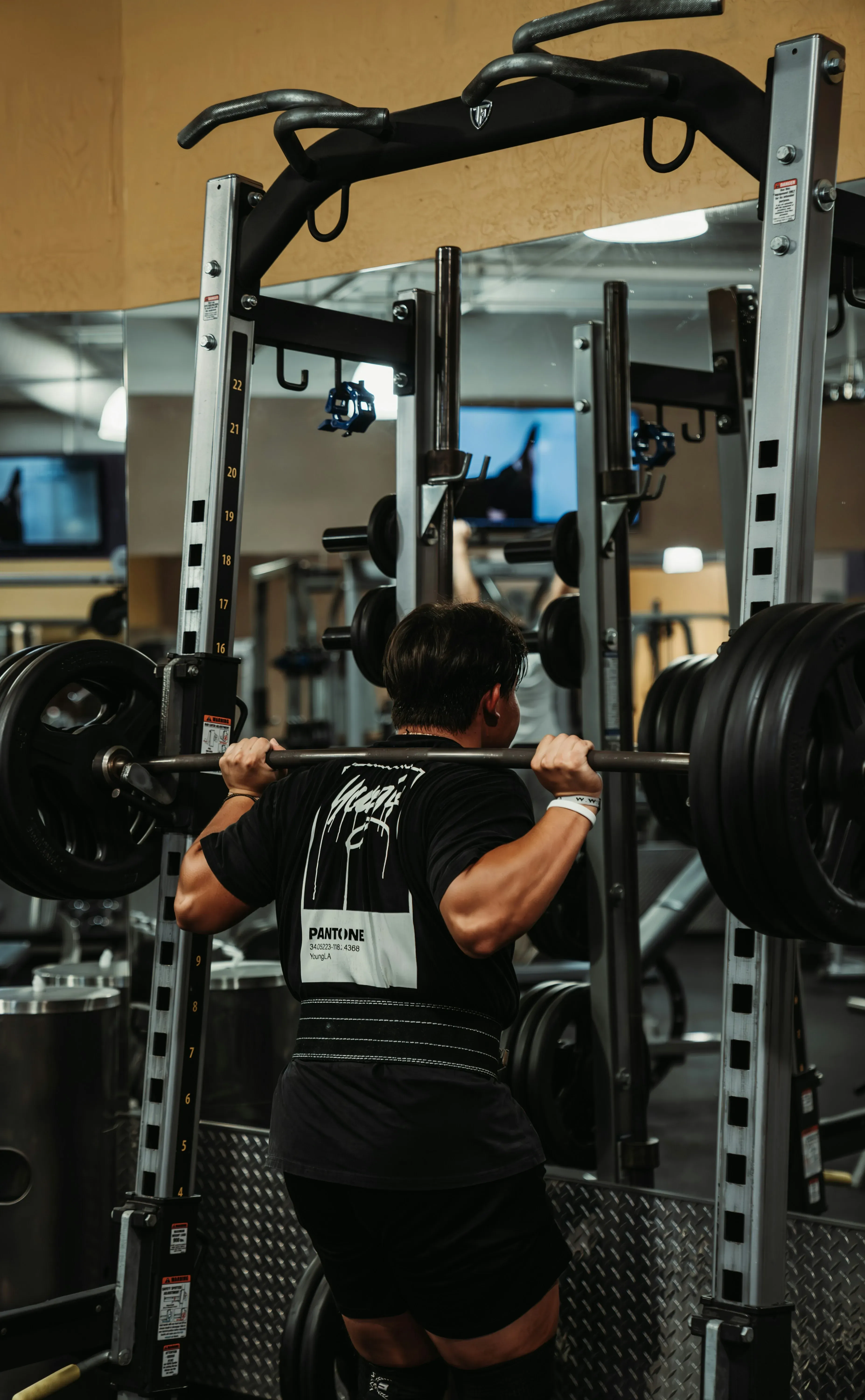 Member performing barbell squat